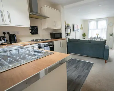 a kitchen and living room with a couch in it at Miles Home Anfield-Liverpool in Liverpool