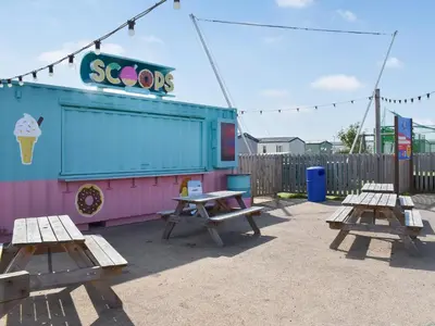 two picnic tables in front of a ice cream shop at Peachy in Heysham