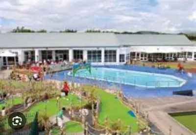 a large swimming pool in front of a building at Vinchella-3 bedroom caravan in Grange Over Sands