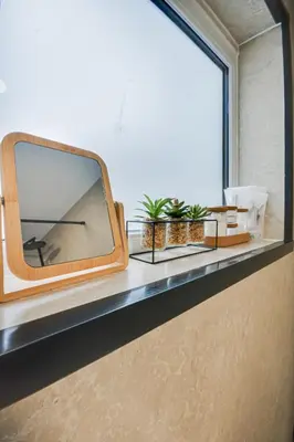 a mirror sitting on a window ledge with plants at Ripon By Serene Stays Stylish Liverpool Home Sleeps 5 with Free Parking Fast WiFi and Close to Stadiums in Liverpool