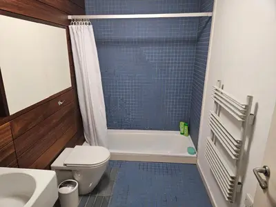 a bathroom with a toilet and a tub and a sink at Cable House, Liverpool City Centre in Liverpool