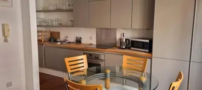 a small kitchen with a glass table and chairs at Cable House, Liverpool City Centre in Liverpool