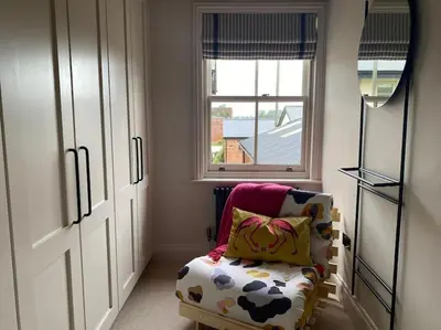 a small room with a chair and a window at The Bothy Cottage in Lytham St Annes