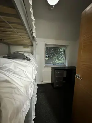 a bedroom with a white bed and a window at Cozy 3-Bedroom House in Bolton, Huge Garden in Egerton