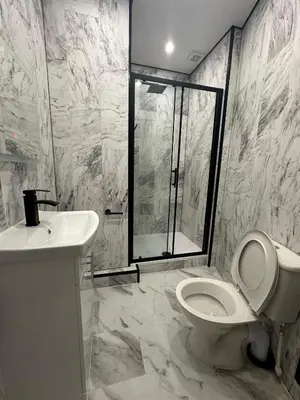 a bathroom with a shower and a toilet and a sink at Luxury rooms Liverpool in Seacombe