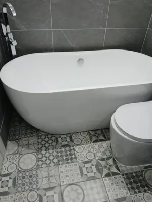 a bathroom with a toilet and a bath tub at The White House in Barrow in Furness