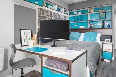 a bedroom with a desk and a bed with blue shelves at Studio In Central Liverpool, Free Breakfast in Liverpool