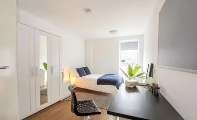 a bedroom with a bed and a desk with a chair at Cosy Budget En-suites, Optional Kitchen, Liverpool in Liverpool