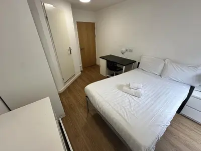 a bedroom with a white bed and a desk at Cosy Budget En-suites, Optional Kitchen, Liverpool in Liverpool
