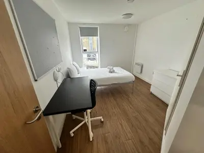 a hospital room with a bed and a desk at Cosy Budget En-suites, Optional Kitchen, Liverpool in Liverpool