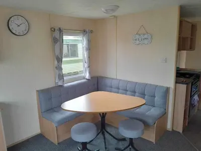 a living room with a blue couch and a table at Escape to the bay- arnside escapes in Morecambe