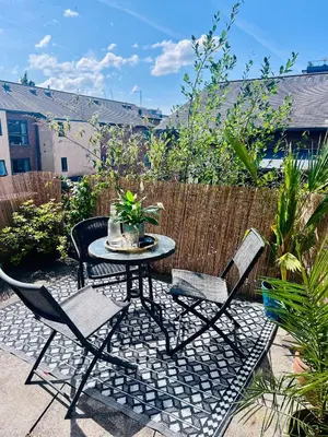 a patio with a table and chairs and a fence at Ropewalks City Centre Apartment with Roof Terrace in Liverpool