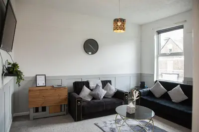 a living room with a couch and a table at Spacious 2-Bedroom Flat with 4 Beds, Ideal for Contractors, Long Stay Deals in Wallasey