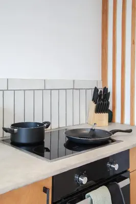 a stove top with two pans on top of it at Spacious 2-Bedroom Flat with 4 Beds, Ideal for Contractors, Long Stay Deals in Wallasey