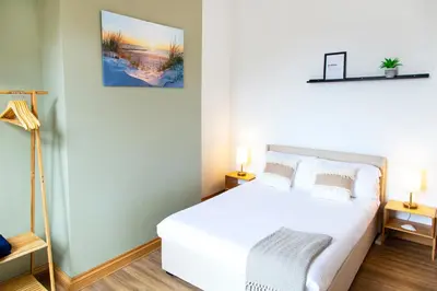 a bedroom with a white bed and two lamps at Eco-Friendly Stay in Barrow-In-Furness, Lake District in Barrow in Furness