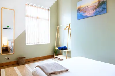 a bedroom with a bed and a large mirror at Eco-Friendly Stay in Barrow-In-Furness, Lake District in Barrow in Furness