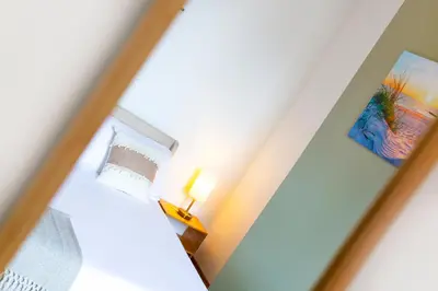 a view of a bedroom through a mirror at Eco-Friendly Stay in Barrow-In-Furness, Lake District in Barrow in Furness