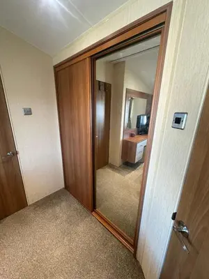a room with a door with a mirror and a bathroom at Seaside breaks morcambe in Heysham