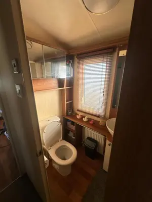 a small bathroom with a toilet and a sink at Seaside breaks morcambe in Heysham