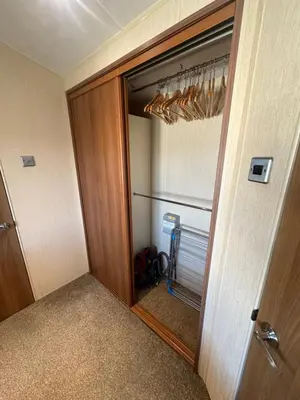 a room with a door and a closet with a mirror at Seaside breaks morcambe in Heysham