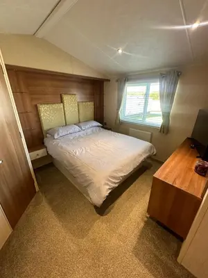 a bedroom with a large bed and a window at Seaside breaks morcambe in Heysham