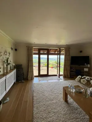 a living room with a table and a television at The View in Oswaldtwistle
