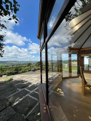 a house with glass doors and a view of a patio at The View in Oswaldtwistle