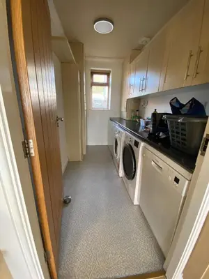 a laundry room with a washer and dryer at The View in Oswaldtwistle