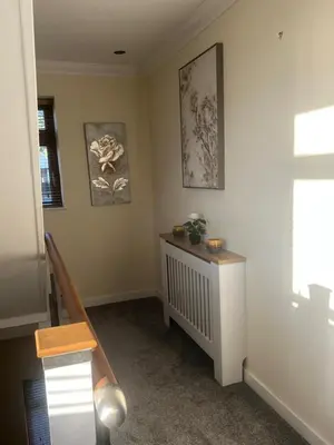 a living room with a staircase and a window at The View in Oswaldtwistle