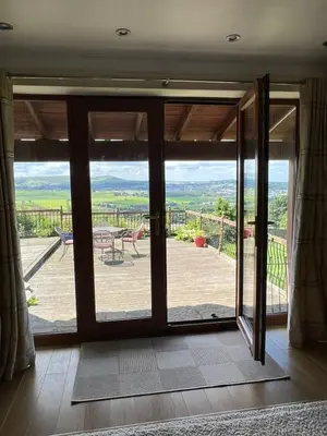 a sliding glass door with a view of a deck at The View in Oswaldtwistle