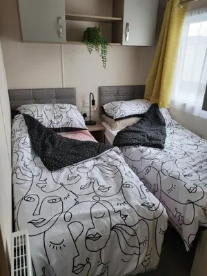 a bedroom with two beds with pillows on them at Angie stunning holiday home in Heysham