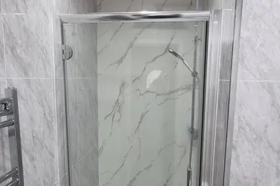 a shower with a glass door in a bathroom at The Hideaway Cottage Feel Patio Central Parking in Southport