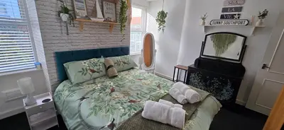 a bedroom with a bed with towels on it at The Hideaway Cottage Feel Patio Central Parking in Southport