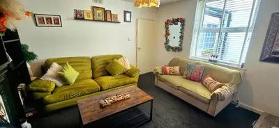 a living room with a couch and a coffee table at The Hideaway Cottage Feel Patio Central Parking in Southport