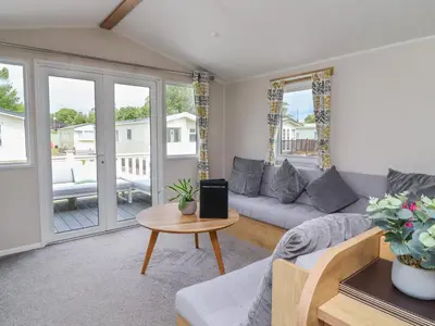 a living room with a couch and a table at Windermere Lodge in Morecambe