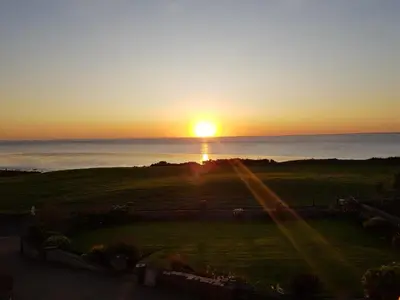 a sunset from the balcony of a house at Half Moon Bay in Heysham
