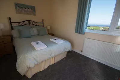 a bedroom with a bed with two towels on it at Half Moon Bay in Heysham