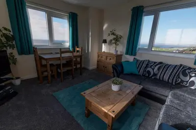 a living room with a couch and a table at Half Moon Bay in Heysham