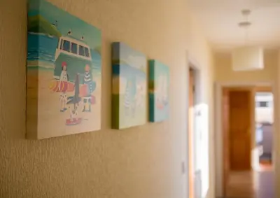 a row of pictures hanging on a wall at Half Moon Bay in Heysham