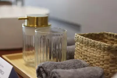 a table with a glass and a basket on it at Home in Chorley, Lancashire in Chorley