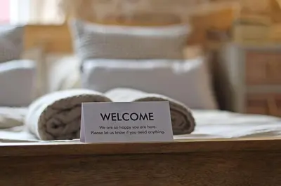 a table with towels and a welcome sign on it at Home in Chorley, Lancashire in Chorley