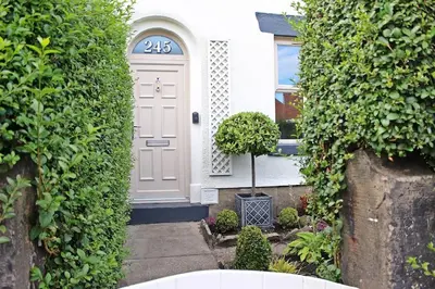 a white house with a door with a number at Home in Chorley, Lancashire in Chorley