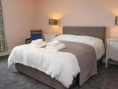 a bedroom with two beds with white towels on them at 3 Cowper Place in Clitheroe
