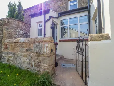 a house with a gate and a stone wall at 3 Cowper Place in Clitheroe