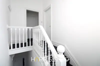 a white staircase in a room with a stair case at Roundtree & Berry - Fleetwood in Fleetwood