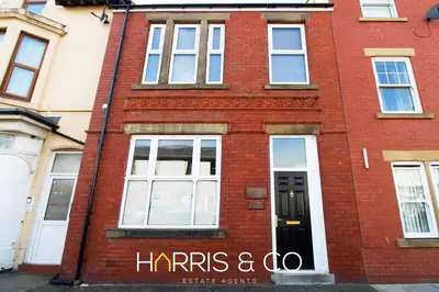 a red brick building with a harris and co sign on it at Roundtree & Berry - Fleetwood in Fleetwood