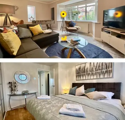 a living room with a couch and a tv at Charles Alexander Short Stay - Derbe House in Lytham St Annes