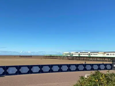 a view of a beach with a pier at Charles Alexander Short Stay - Derbe House in Lytham St Annes