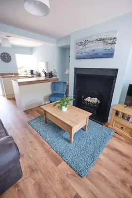 a living room with a coffee table and a fireplace at Olivia Cottage - a Home From Home by the Sea in Morecambe
