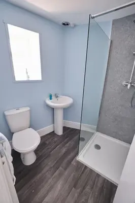 a bathroom with a toilet and a sink at Evie Cottage - The peaceful Retreat in Morecambe